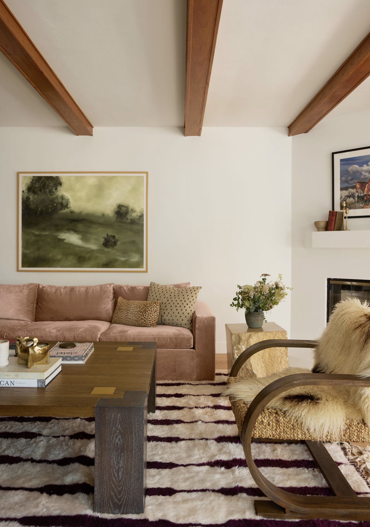 Living room with pink sofa and landscape painting